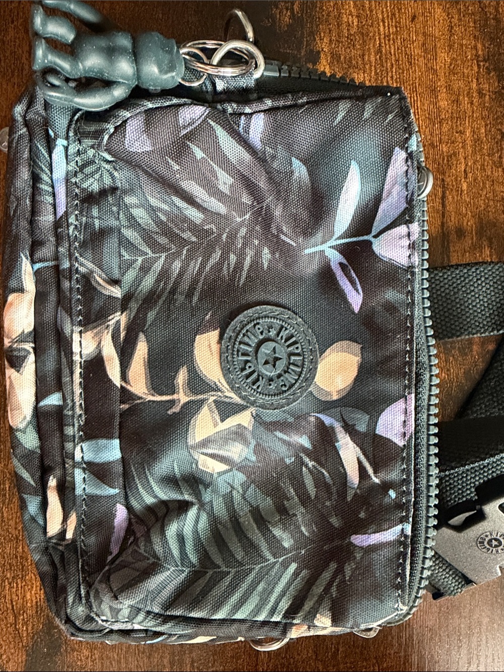 Kipling Black Floral Belt Bag with Pastel Leaf Print